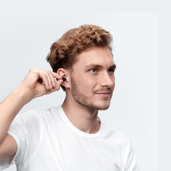 Young man inserting WorkSafe Earplugs into his ears